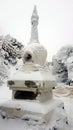 Old Buddhist Stupa covered in snow. Shad Tchup Ling Buddhist monastery. Kachkanar mountain, Ural, Russia