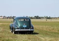 Old Buick driving on field