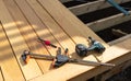 Old builders tools and red string on new wooden decking under construction Royalty Free Stock Photo