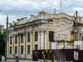 An old building architecture in Kharkiv, Ukraine. Bicyclist and metal fence