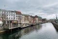 Old building at the bank of canal in old town of Copenhagen city with cloudy sky