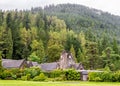 An old building with clock with an exhibition of local artists paintings for sale at Benmore Botanic Garden, Scotland