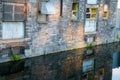 Old building closeup reflected in canal below.