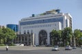 The old  building with a dark tuff facade is complemented by a new white high-rise building decorated with blue glass on Shahumyan Royalty Free Stock Photo