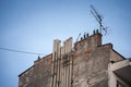 Old building with decaying chimneys in an urban setting, highlighting the effects of time and pollution on city infrastructure Royalty Free Stock Photo