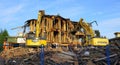 Old building demolition. Excavator working at the construction site. Royalty Free Stock Photo