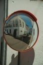 OlÃÂ¡ Old building on empty alley corner reflected in street mirror