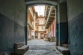 Old building entrance behind arch in Lvov yard. Royalty Free Stock Photo