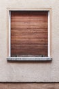 Old building exterior in Bamberg, Germany. Window with closed wooden shutter. Warm colors, minimalistic design. Royalty Free Stock Photo