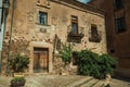 Old building facade with green creeper, on corner of narrow alley at Caceres Royalty Free Stock Photo