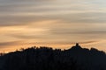 Old building on a forested mountain silhouetted