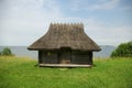 Old building with grass roof by the sea Royalty Free Stock Photo