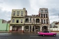 HAVANA, CUBA - OCTOBER 21, 2017: Old Building in Havana, Unique Cuba Architecture. Moving car in foreground Royalty Free Stock Photo