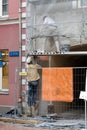 Riga, Latvia, November 2019. Restoration of an old building, two workers plastering the facade. Royalty Free Stock Photo