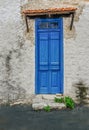 Old blue wooden doors that are shut.