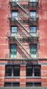 Old building with iron fire escape, color toning applied, New York City, USA