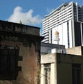 Old building juxtaposed in front of modern building with mosque in between Royalty Free Stock Photo