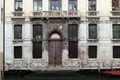 Old building with many windows and a door with arc in Venice, Italy Royalty Free Stock Photo