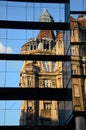 An Old Building On A New Building Reflection. Royalty Free Stock Photo