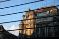 An Old Building On A New Building Reflection. Royalty Free Stock Photo