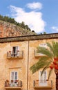 Old building and palm tree at the cathedral square of Cefalu, Si Royalty Free Stock Photo