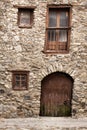Old building rocks and stones maded. Wooden door and windows crooked