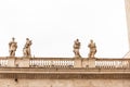 Old building with roman statues under grey sky