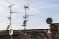 Old building roof with many different type receiver telecommunication antennas Royalty Free Stock Photo