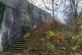 Old building ruins with stone column archway and overgrown stone stairway Royalty Free Stock Photo