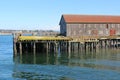 An old building on a run down pier in a bay Royalty Free Stock Photo