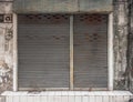 Old building with a rusty roller shutter door Royalty Free Stock Photo
