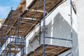 Old building under construction with scaffolds. Construction site. Scaffolding on multi storey building facade during renovation Royalty Free Stock Photo