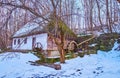 The old building of water mill at the snowy hill, Bukovyna Region, Pyrohiv Skansen, Kyiv, Ukraine