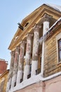 old building with wooden carved columns. A forgotten winter view Royalty Free Stock Photo
