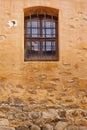 Old Building Yellow Stone Wall With Window And Rusty Bars Royalty Free Stock Photo