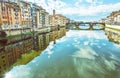 Old buildings and beautiful Ponte Santa Trinita mirrored in the Royalty Free Stock Photo