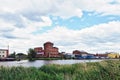 Old buildings of city industrial zone on riverbank