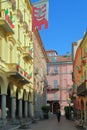 OLD BUILDINGS IN THE DOWNTOWN OF ASTI CITY WITH ITALIAN FLAGS AND PALIO FLAG IN ITALY