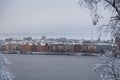 Old buildings by the river on a damp winter day with snow and mist, Stockholm Sweden Royalty Free Stock Photo