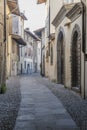 Old builings on bending  cobbled narrow lane in historical town, Rovato, Italy Royalty Free Stock Photo