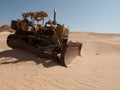 An old bulldozer abandoned in the middle of the desert in Saudi Arabia