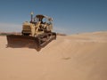 An old bulldozer abandoned in the middle of the desert in Saudi Arabia