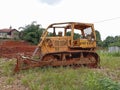 an old bulldozer leveling the construction ground