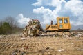 The old bulldozer moving garbage