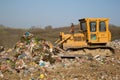 The old bulldozer moving garbage