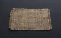 Old burlap fabric napkin on black background Royalty Free Stock Photo