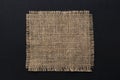 Old burlap fabric napkin on black background, top view Royalty Free Stock Photo