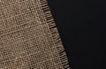 Old burlap fabric napkin on black background, top view Royalty Free Stock Photo