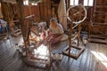 Old burmese woman is spinnig a lotus thread