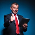 Old business man holding a tablet and making ok Royalty Free Stock Photo